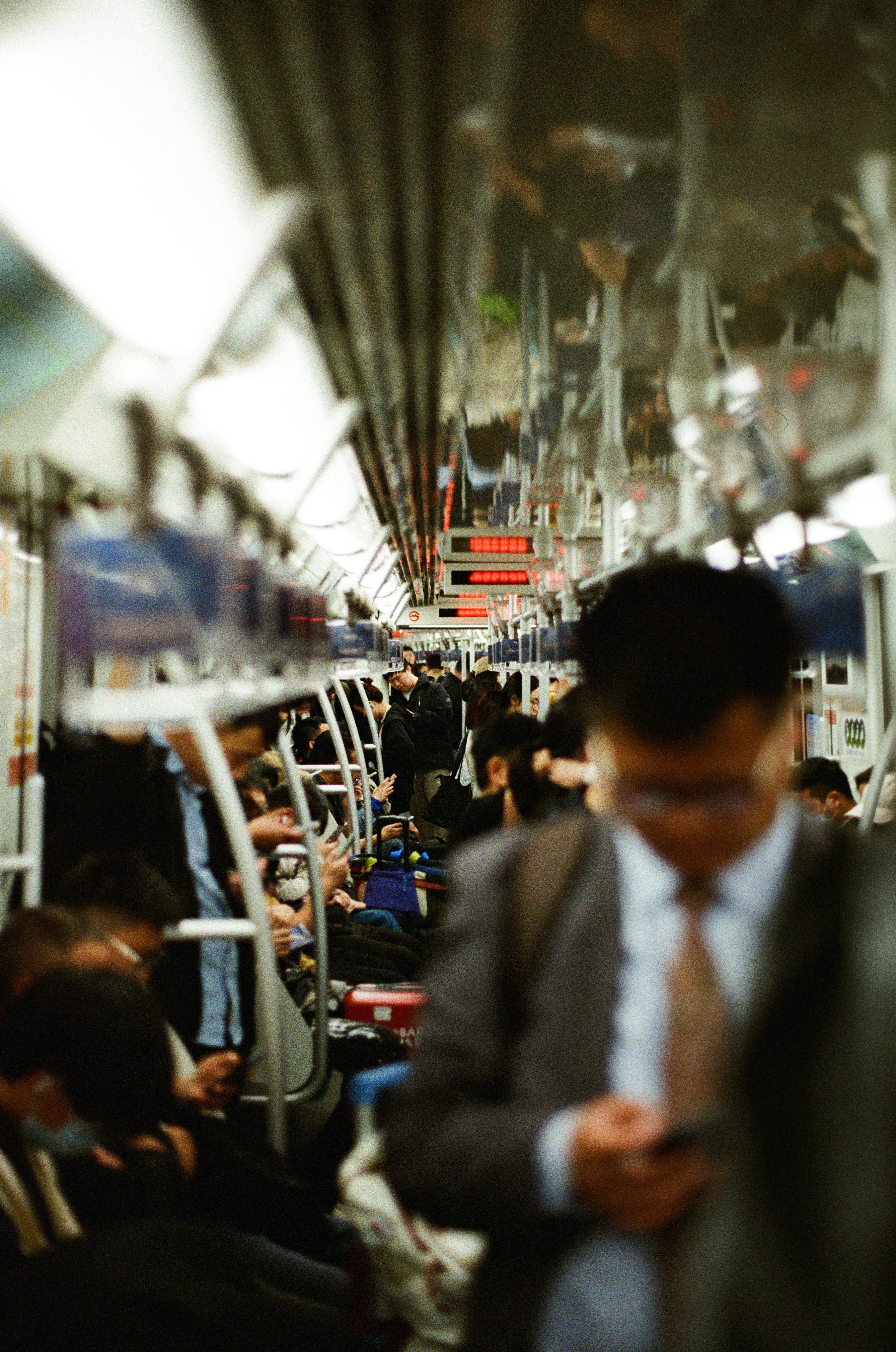 Busy commuters in a Shanghai subway train during rush hour, showcasing urban lifestyle.