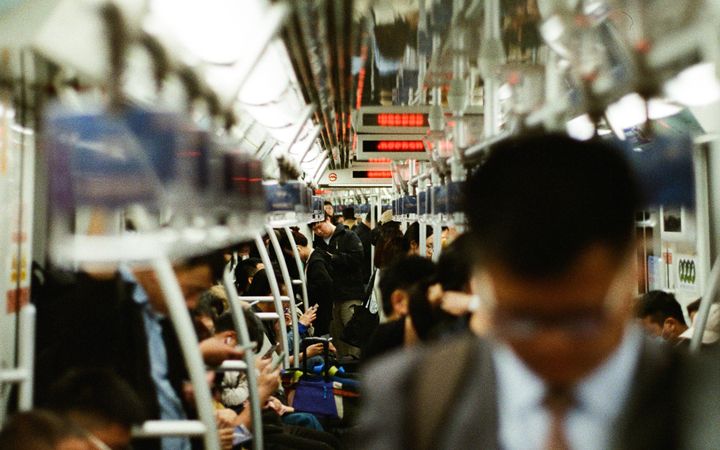 Busy commuters in a Shanghai subway train during rush hour, showcasing urban lifestyle.