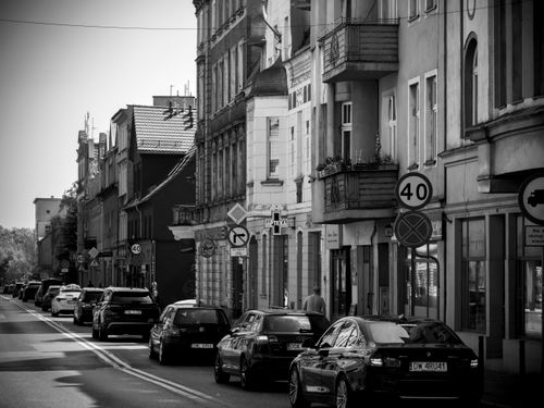 Free Monochrome image of a busy street in Wrocław, Poland showing cars and European architecture. Stock Photo