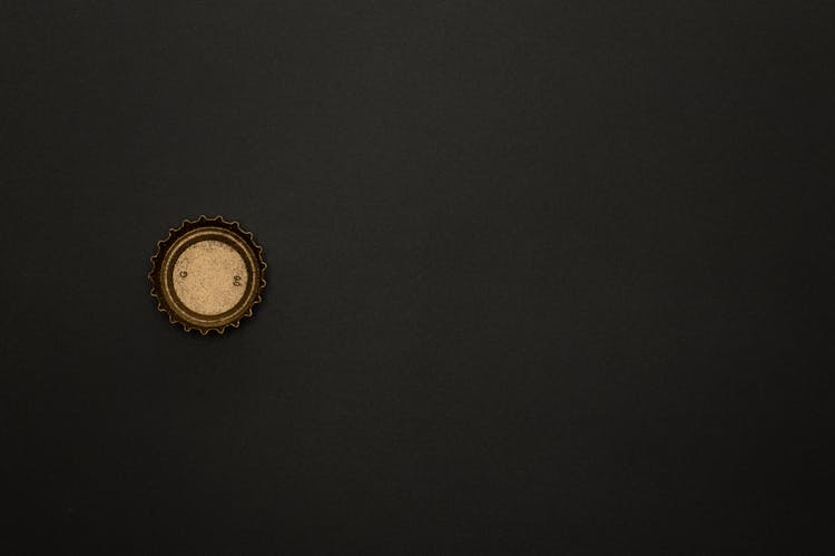 Gold Bottle Top On Black Background