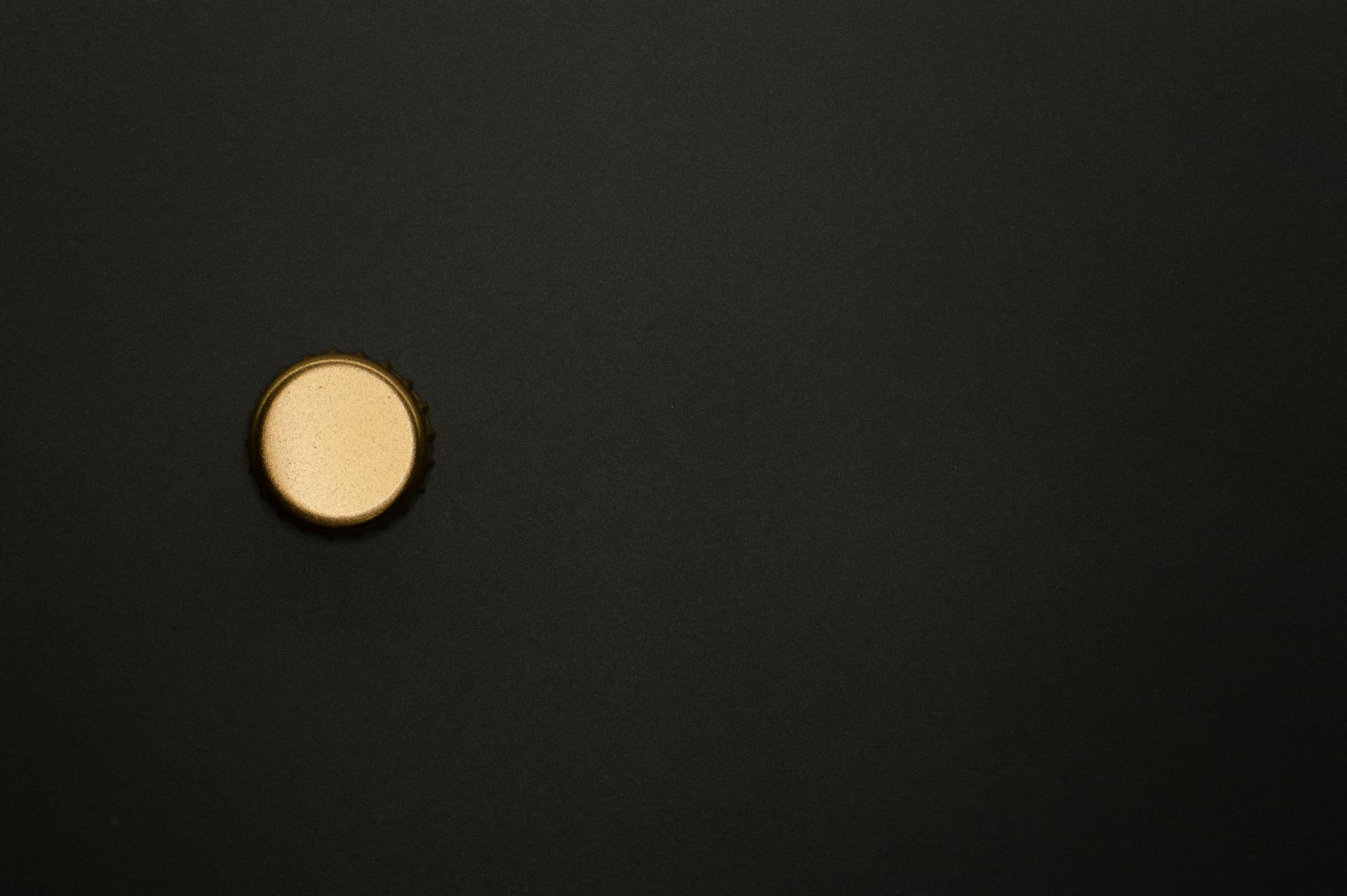 Round Golden Bottle Cap On Black Background