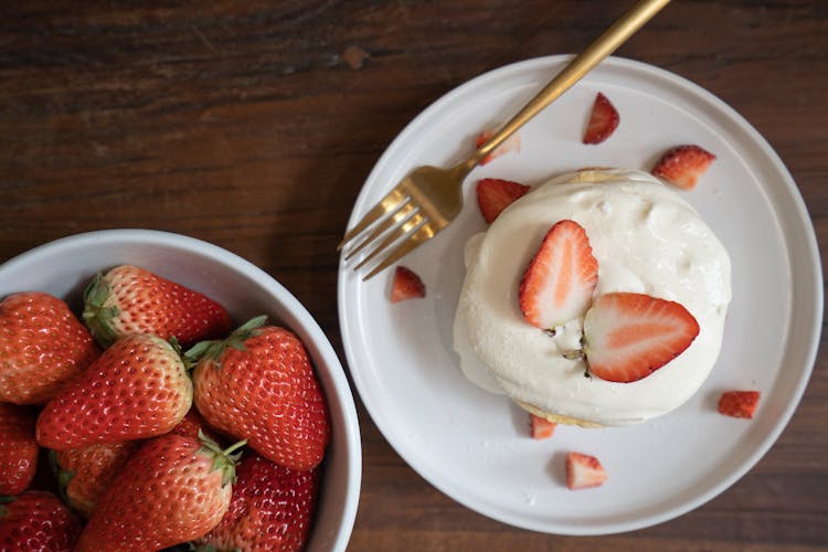 Strawberries On White Ceramic Bowl And Whipped Cream