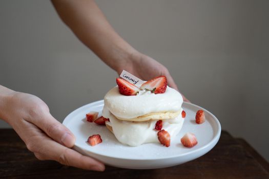 Person Holding A Plate With Strawberry Shortcake