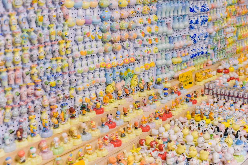 Colorful ceramic figurines on display shelf representing collectible toy industry growth including BaiChaoHui figures