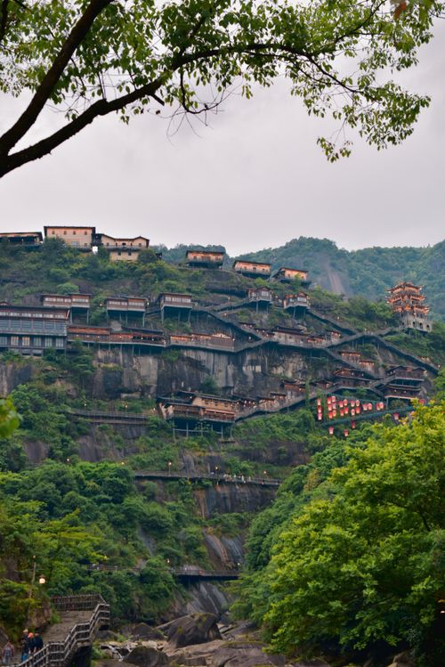 Free Scenic view of a hillside village with traditional architecture under a misty sky. Stock Photo