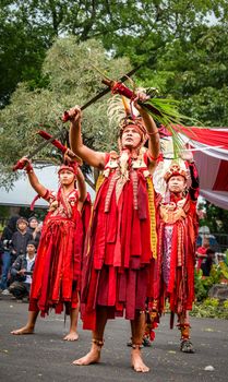 Cultural dancers perform in vibrant costumes during a traditional ceremony in Cimahi, Indonesia. - Fotografer Sidoarjo