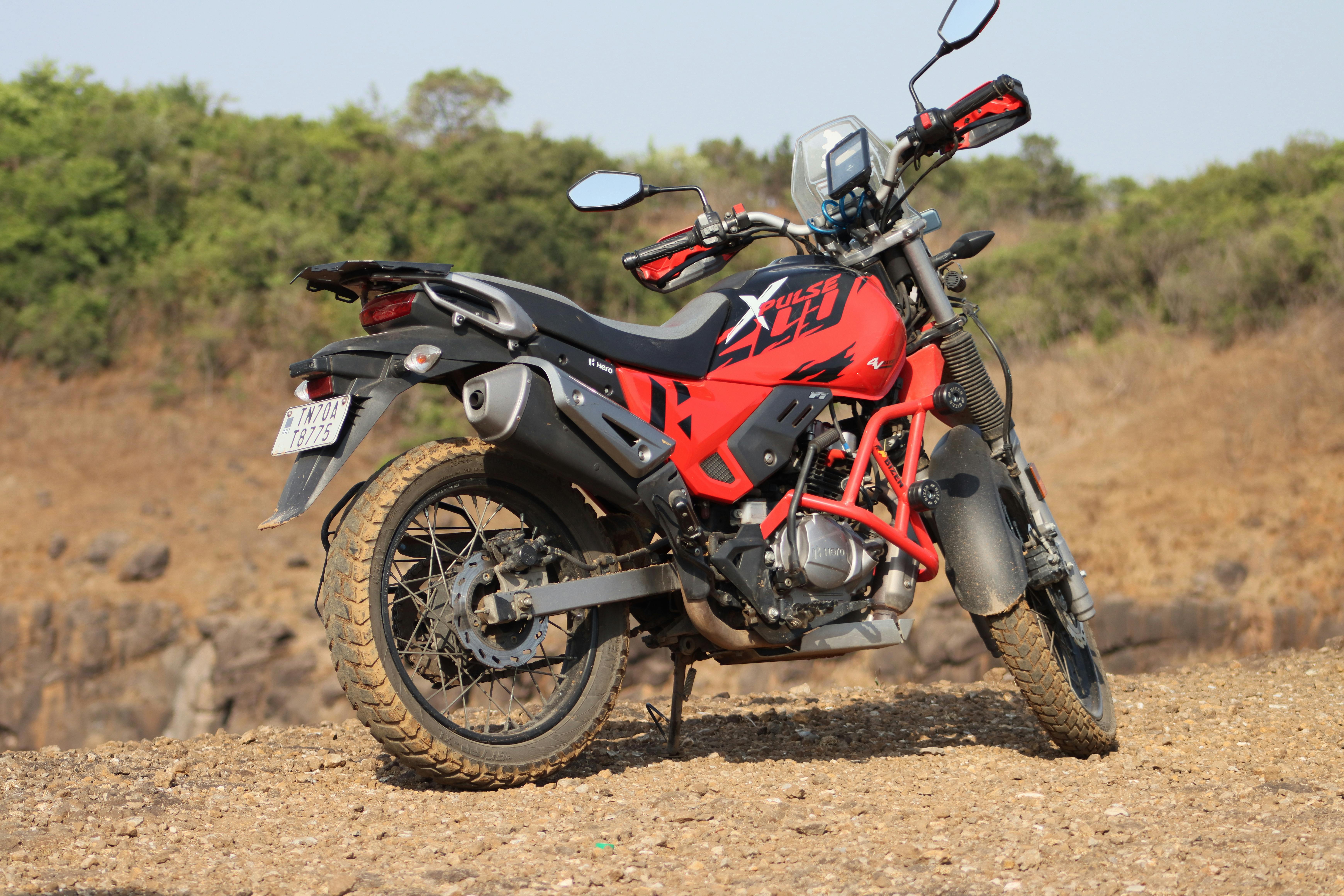 Explore rugged India with a red Hero Xpulse 200 motorcycle for ultimate adventure.