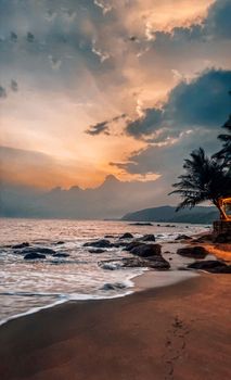 A serene beach at sunset with colorful clouds and palm trees, evoking a tropical paradise.