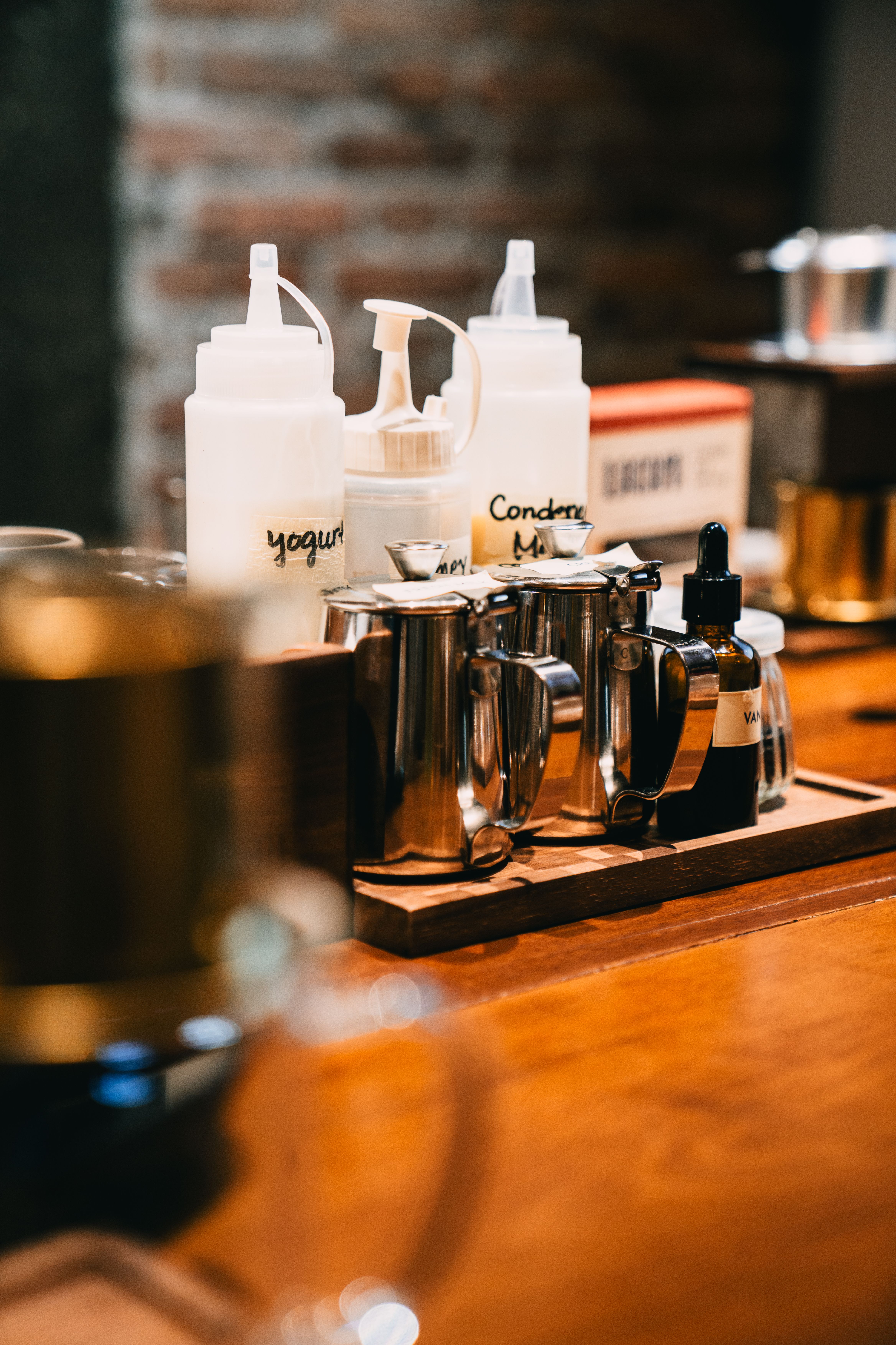 White marble condiment tray holding sugar packets and creamer on an office coffee bar counter