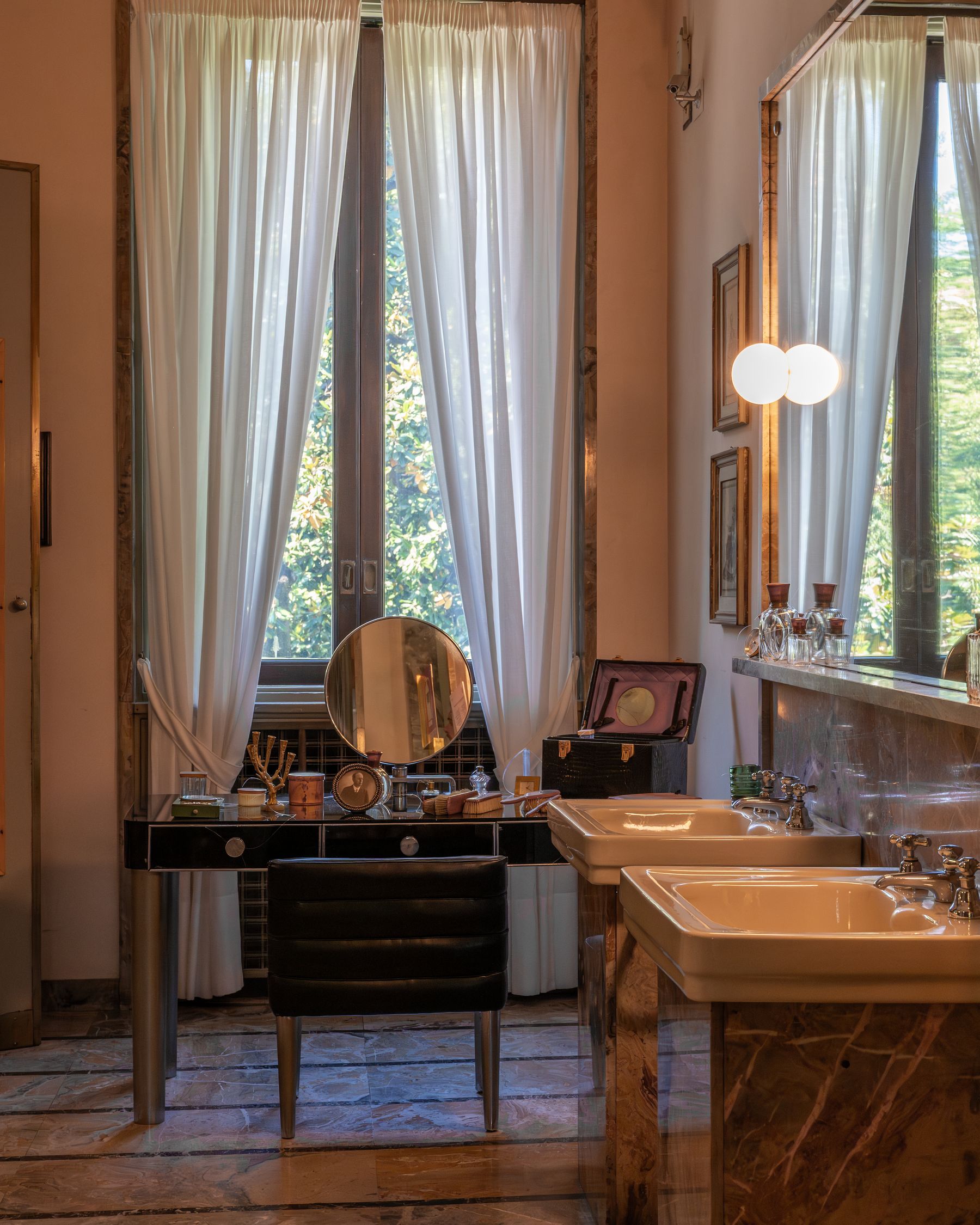 Elegant classic bathroom with marble, natural light, chandelier and timeless decorative details