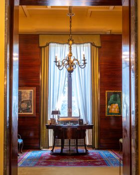 Sophisticated interior design featuring a classic chandelier and elegant curtains in a luxurious setting.