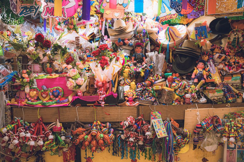 Colorful market stall packed with traditional toys and crafts in Guanajuato, Mexico.