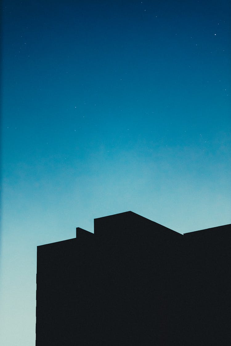 Silhouette Of Modern House Against Blue Night Sky