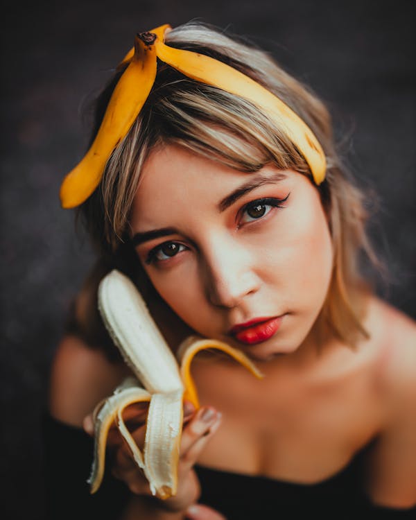Free Close-Up Photo Of Woman Holding Banana Stock Photo