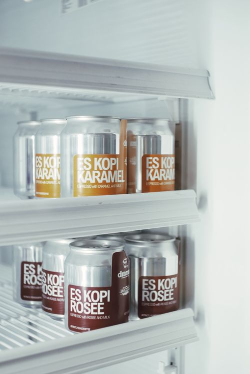 Free Cans of Indonesian Es Kopi Karamel and Rosée chilled in a fridge. Perfect for coffee lovers. Stock Photo