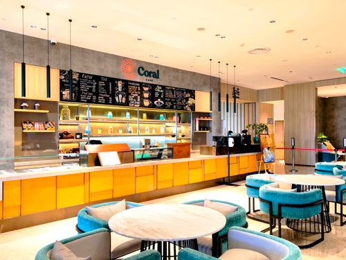 Free Bright and modern cafe interior with blue seating and a sleek counter. Stock Photo