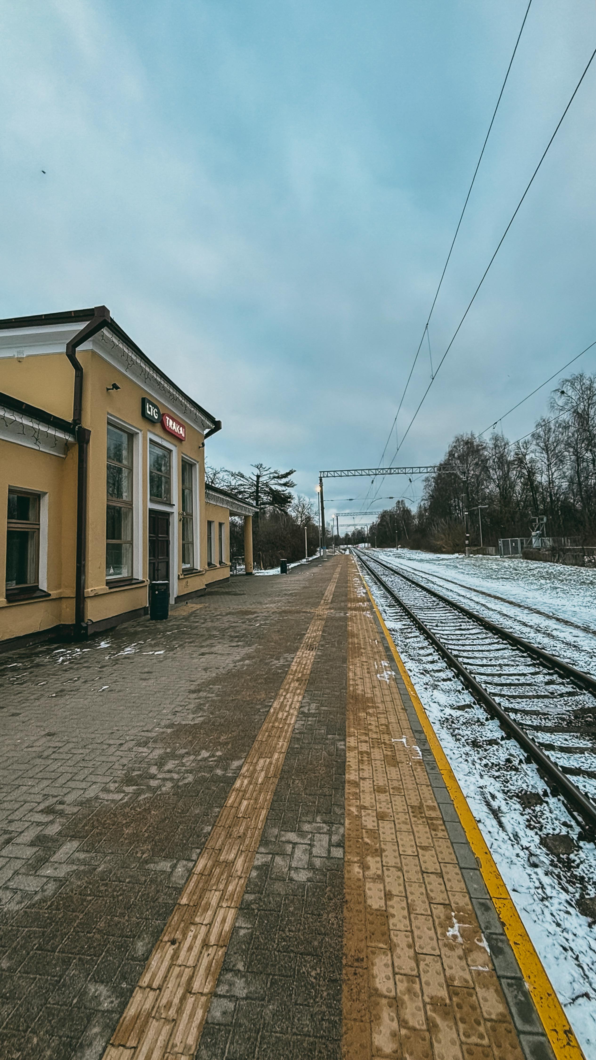 Capture the serene winter atmosphere at a quiet train station in Vilnius, Lithuania.