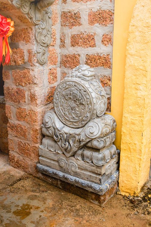 Free Detailed stone sculpture with ornate carvings in a rustic outdoor setting. Stock Photo