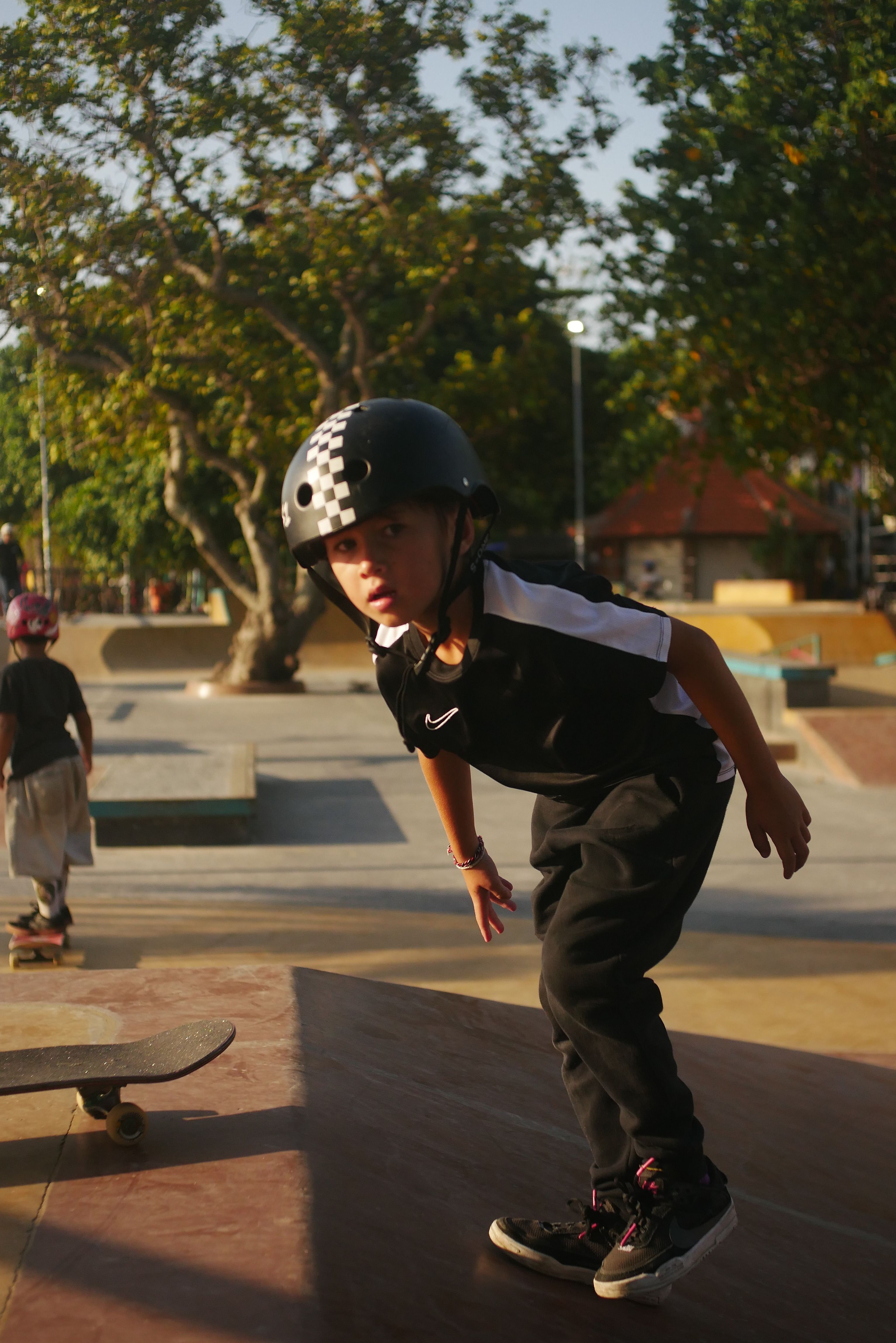 A child skateboarding in Bali, Indonesia, captured during the golden hour, exuding a chill and adventurous vibe.