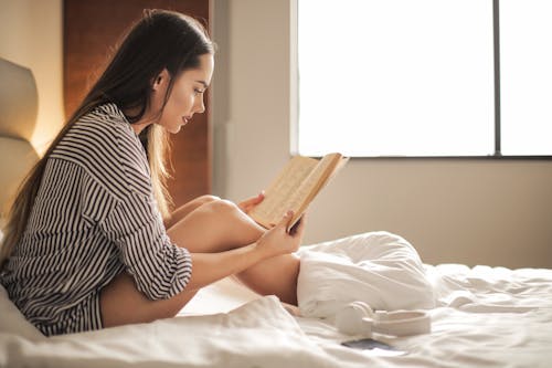 Photo Of Woman Reading Book