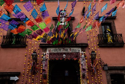 Colorful Day of the Dead decorations adorn a building in San Miguel de Allende, Mexico.