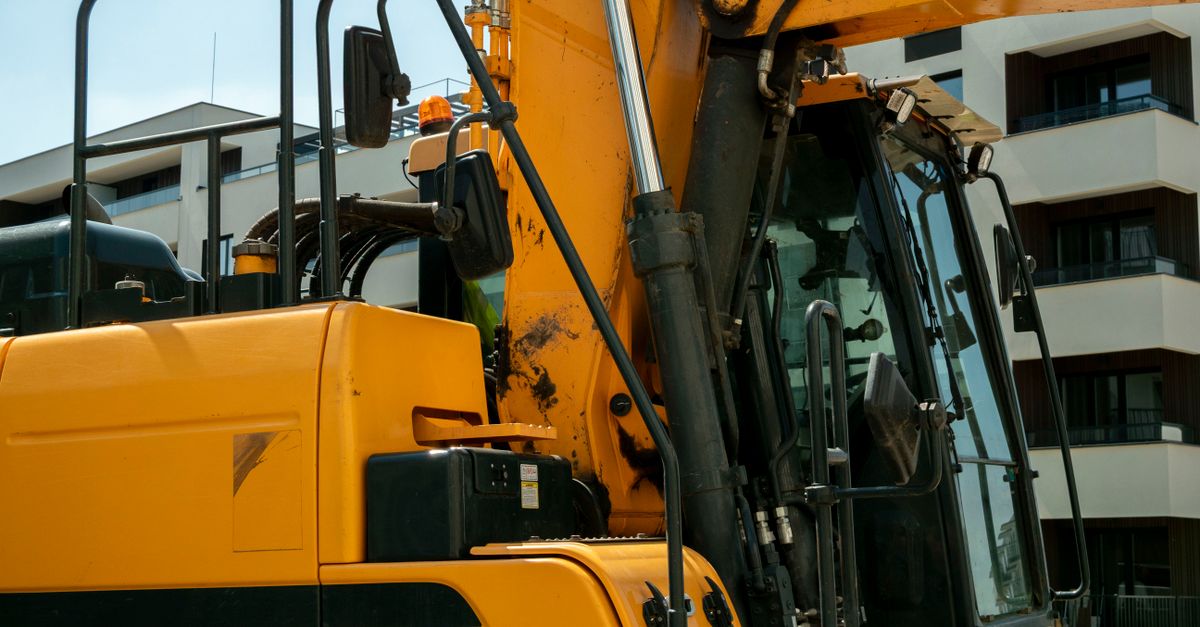 Close-up of a yellow excavator in an urban construction site in Wrocław, Poland.