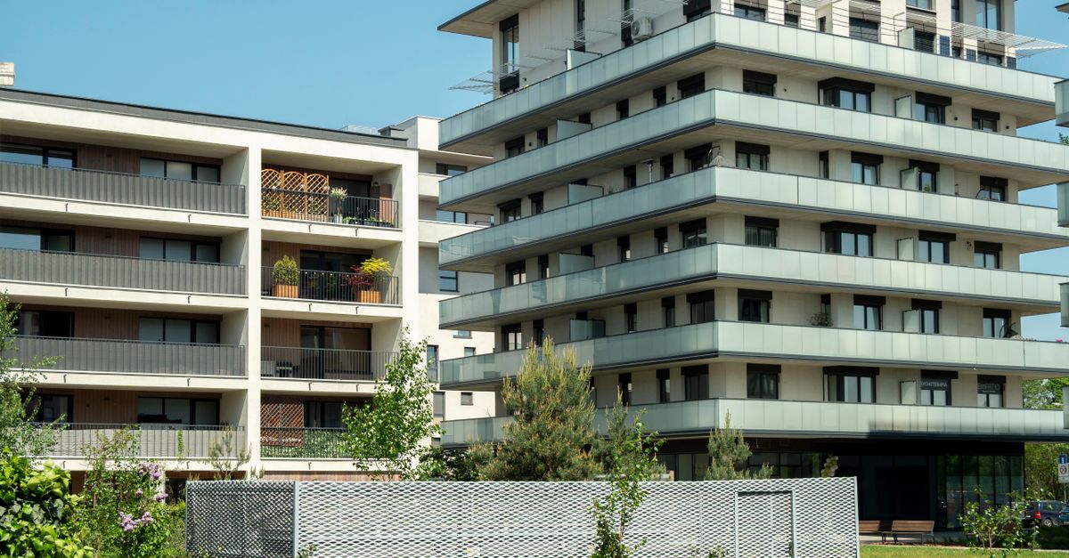 Contemporary apartment buildings in sunny Wrocław, showcasing modern architecture and green surroundings.