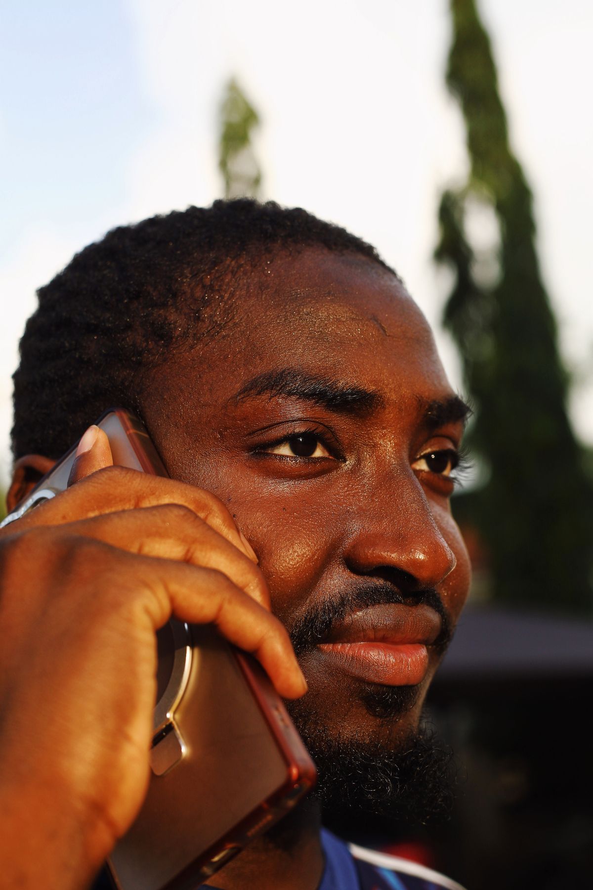 African professional checking a payment on a smartphone