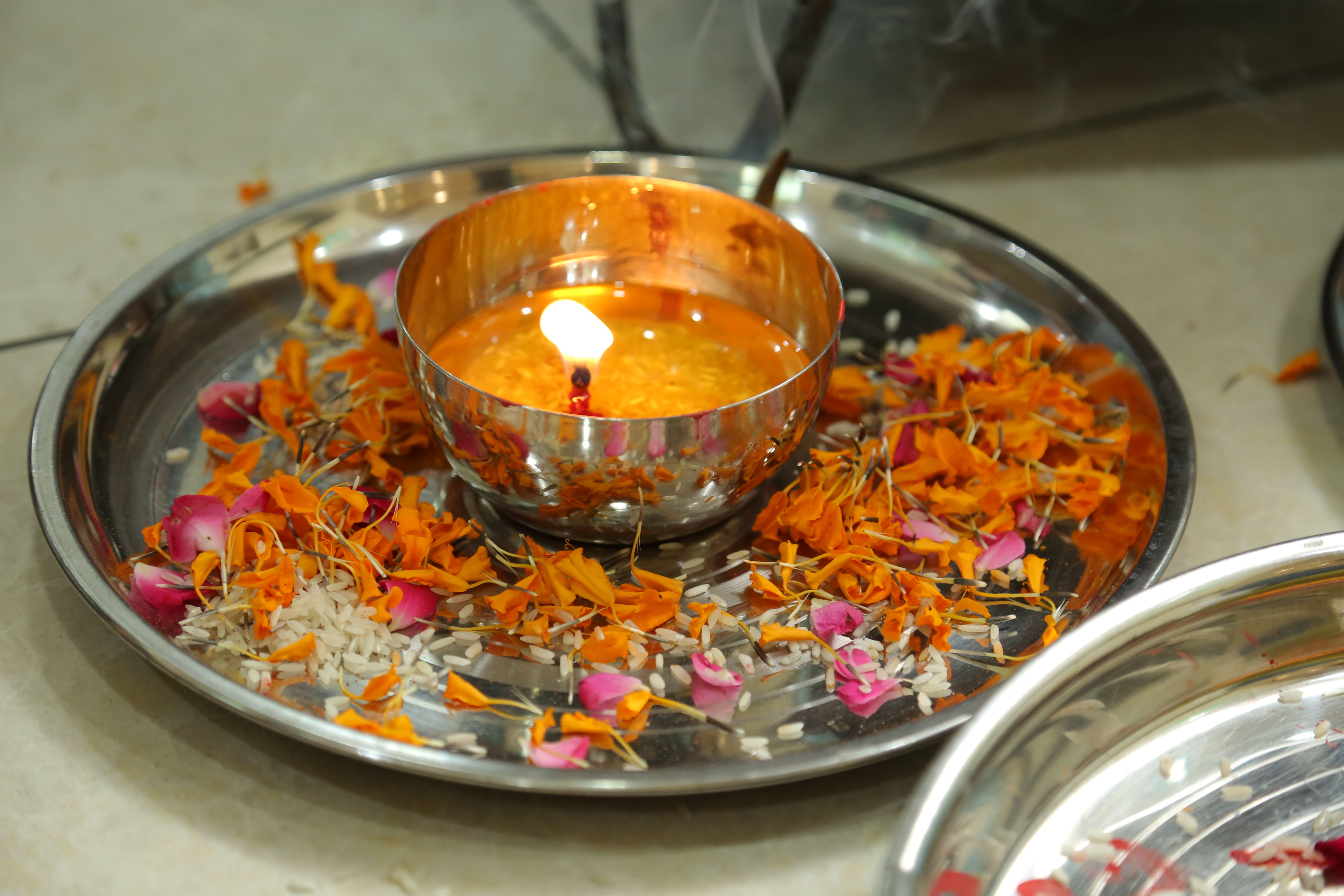 Diya oil lamp and flowers for Indian puja