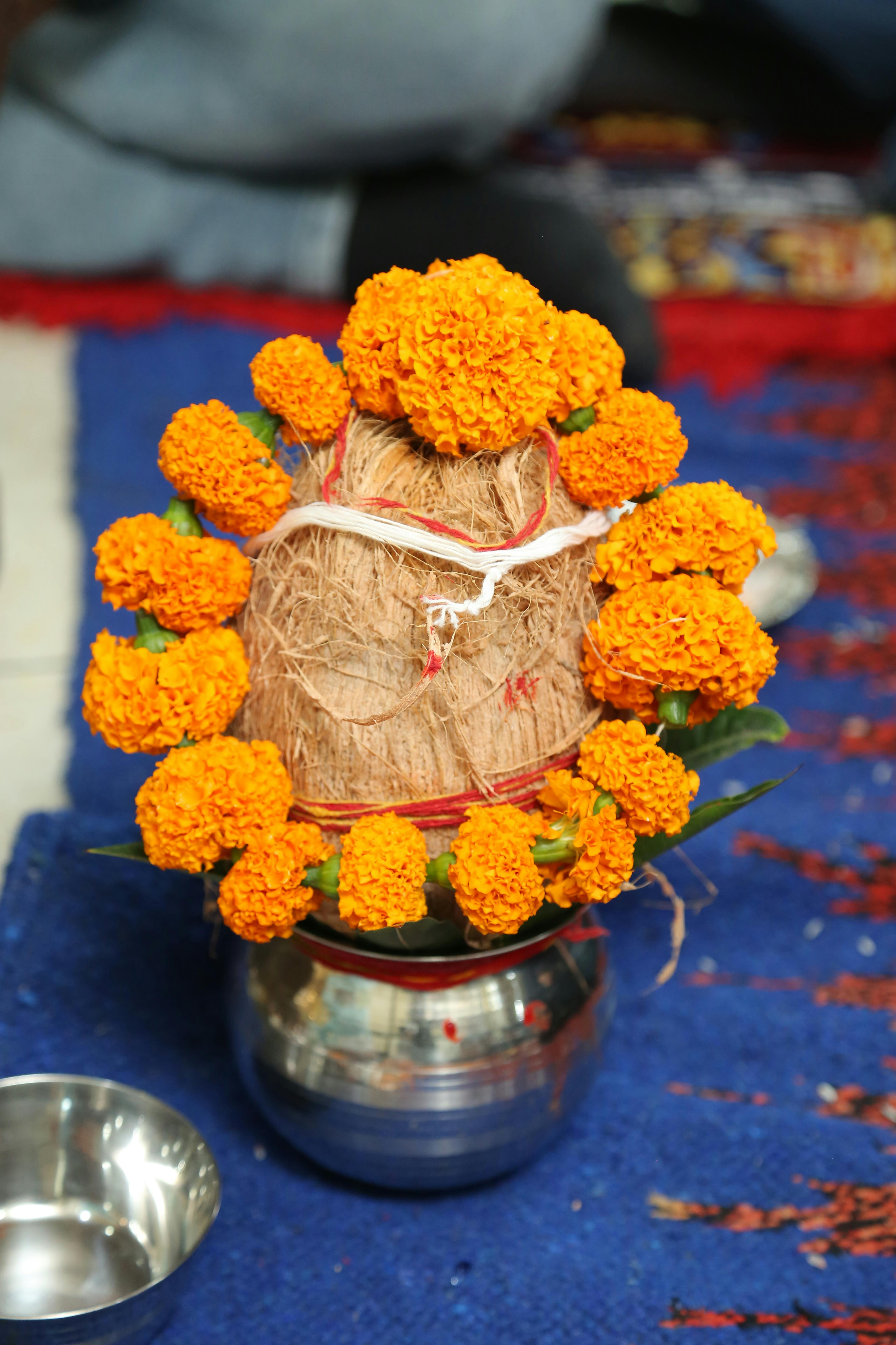 Traditional Indian ritual arrangement with marigolds and coconut, bright and vivid.