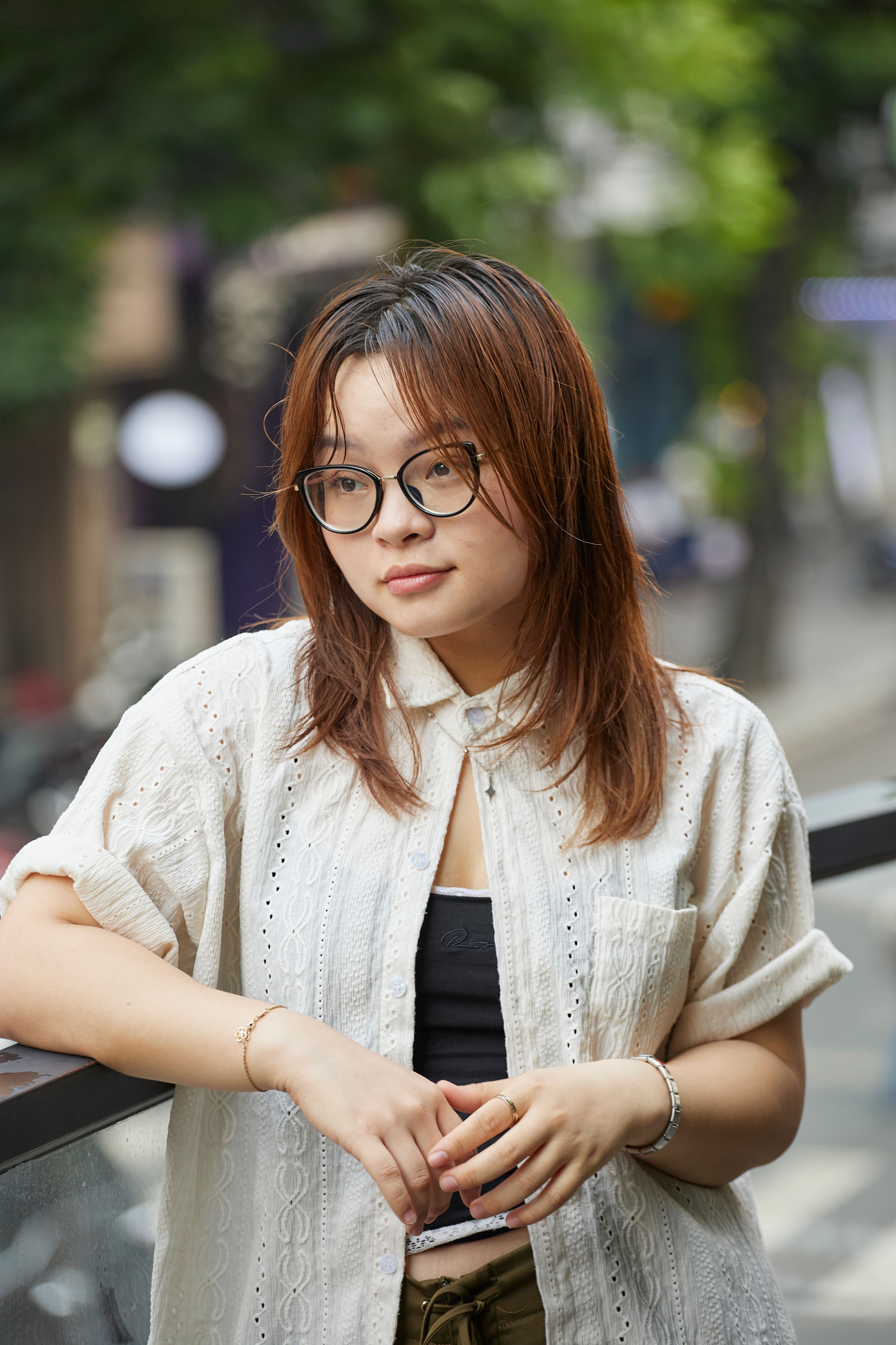 Portrait of a young woman in Ho Chi Minh City, depicting urban lifestyle and fashion.