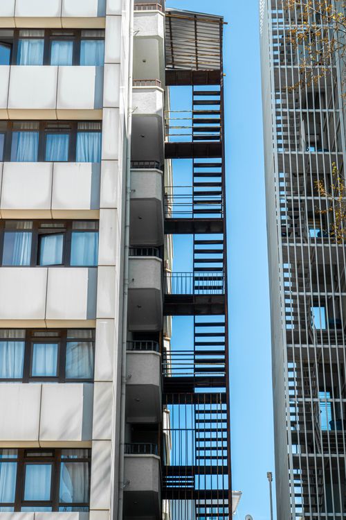 Free Close-up of Ankara buildings highlighting outdoor fire escapes against a clear blue sky. Stock Photo