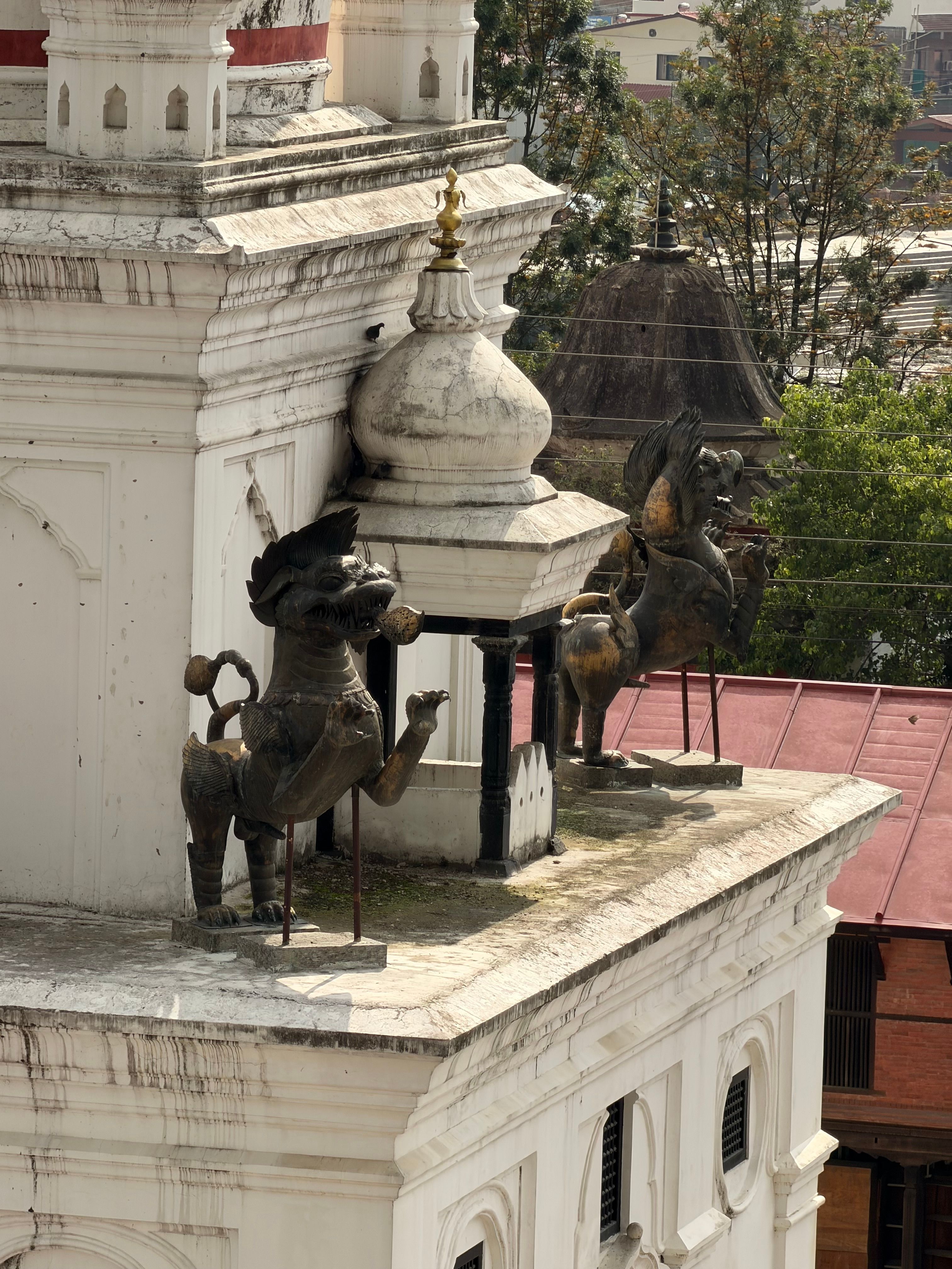 Intricate rooftop sculptures on historic building in Kathmandu, Nepal.