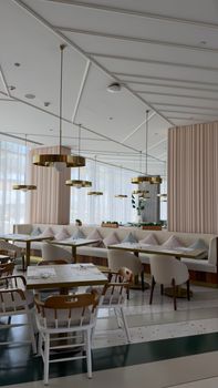 Elegant restaurant interior with stylish furniture and hanging lights, ideal for dining settings.