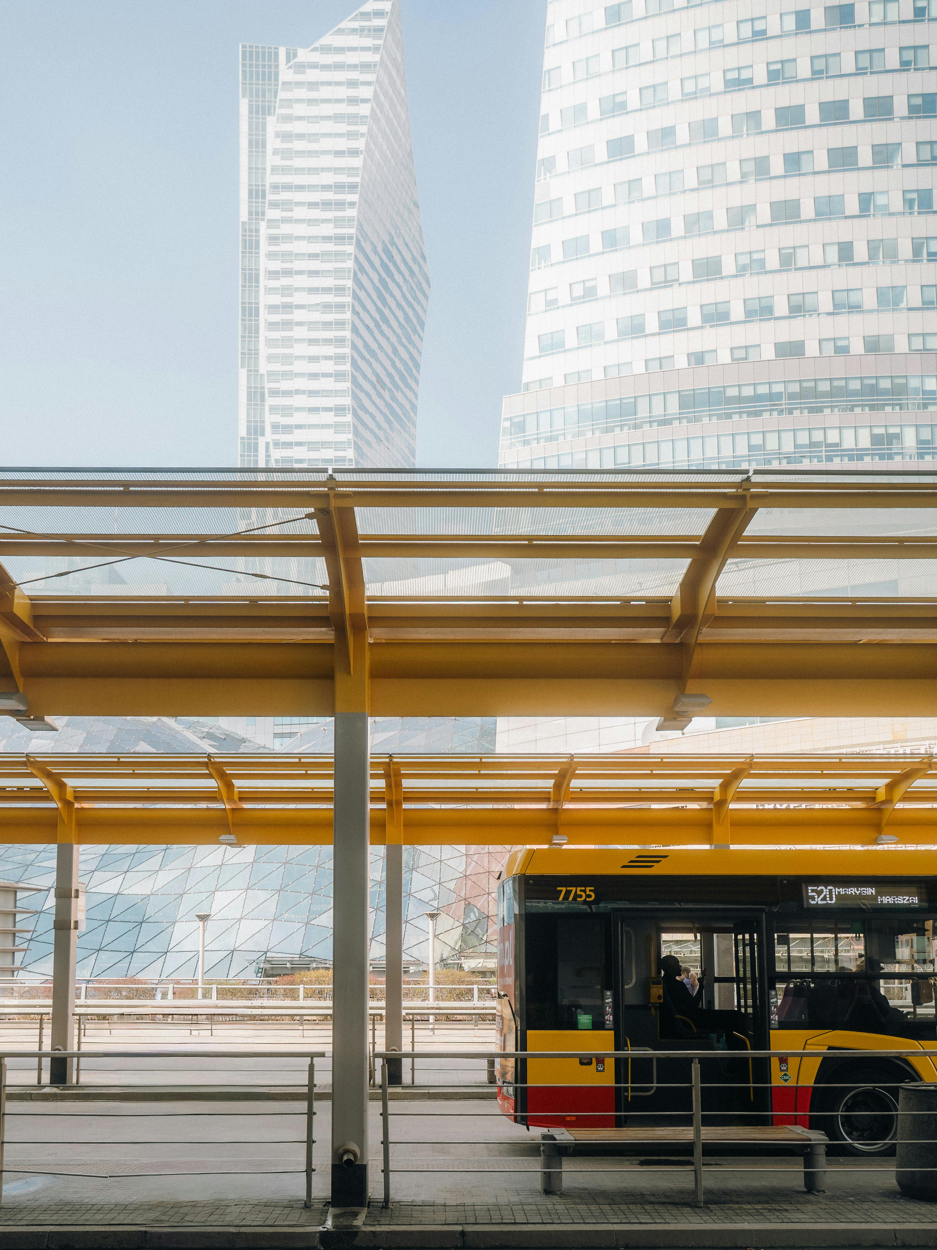 Urban scene of a public bus by modern skyscrapers in Warsaw.