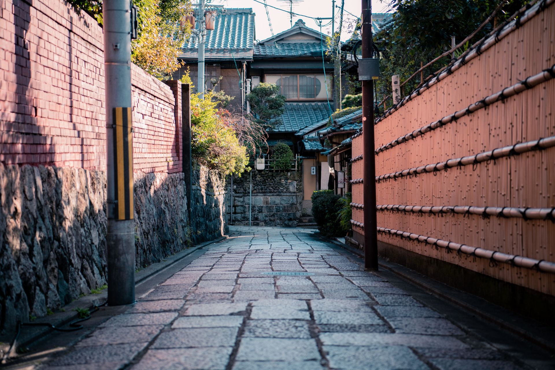 Traditional Japanese alley with cobblestones and architecture in Kyoto.