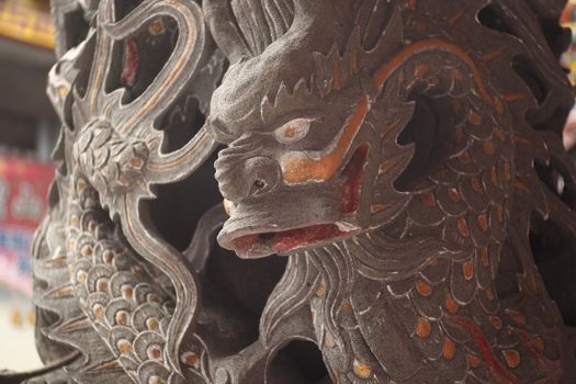 Close-up of a detailed dragon sculpture showcasing artistic stonework and craftsmanship.