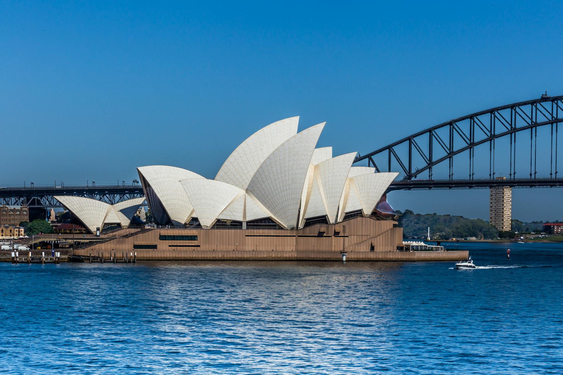 Stunning view of Sydney Opera House and Harbour Bridge across the blue waters.