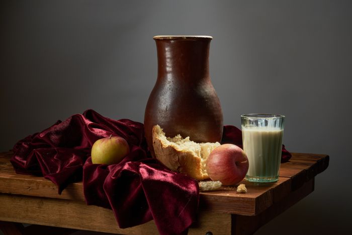 Rustic still life with a jug, apples and bread — photo by Matvei on Pexels