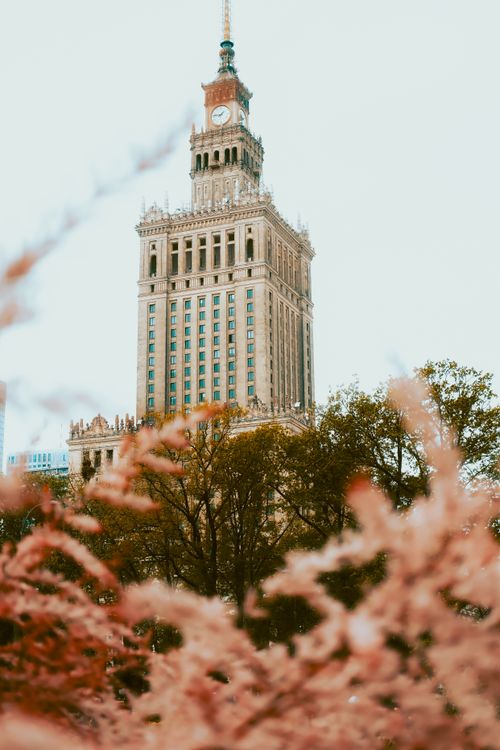 Free A view of the Palace of Culture and Science surrounded by autumn foliage in Warsaw, Poland. Stock Photo