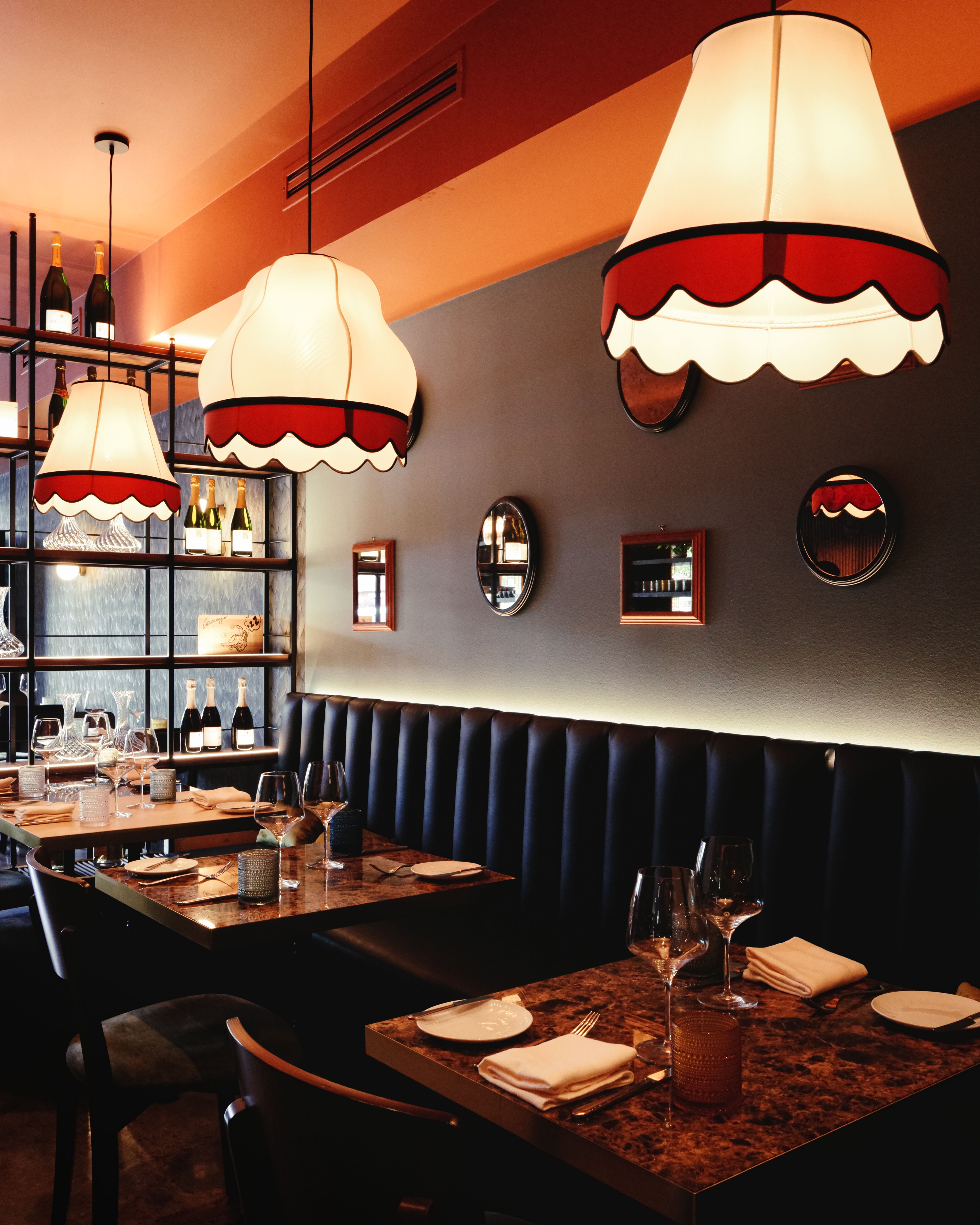 Warm and inviting restaurant interior featuring stylish pendant lights and elegant table settings.