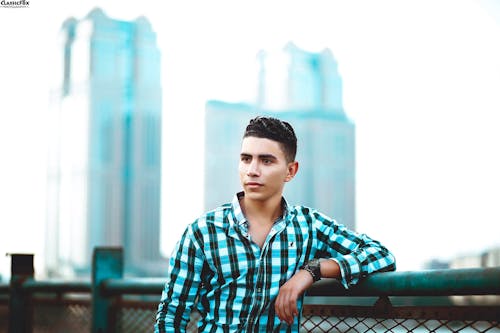 Selective Focus Photo of Man Wearing Blue and Black Sport Shirt