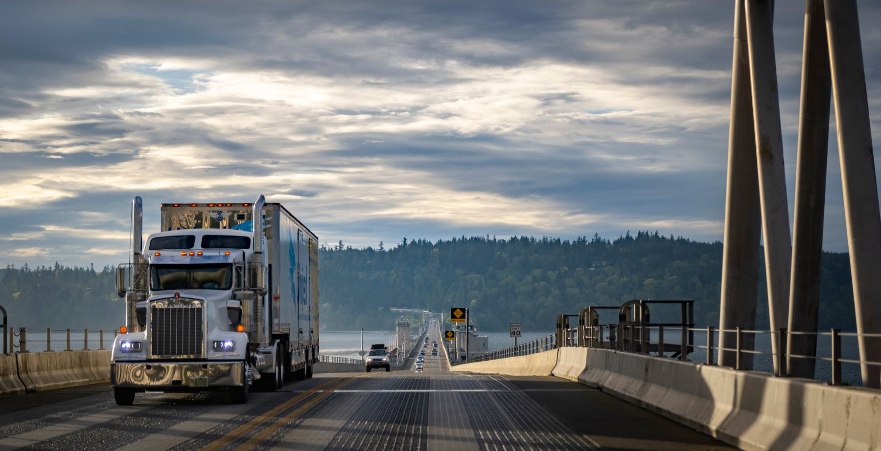 Semi truck crossing a highway bridge in Washington, United States