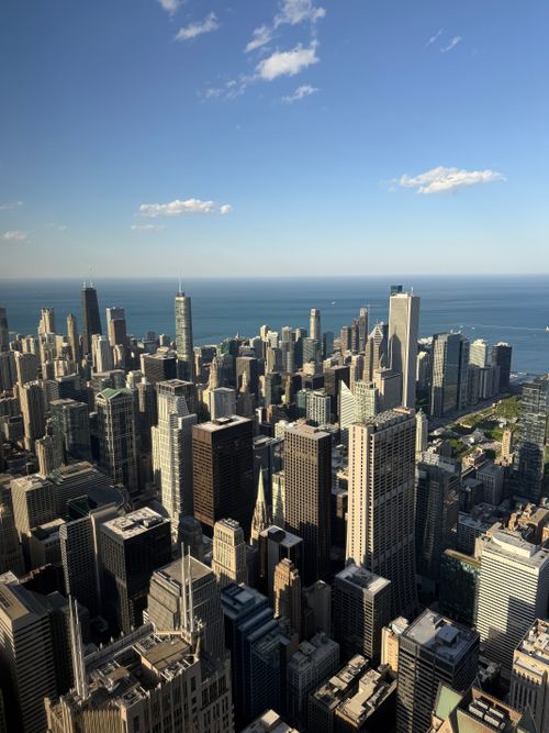 Free Aerial view of Chicago's iconic skyline with Lake Michigan in the backdrop. Stock Photo