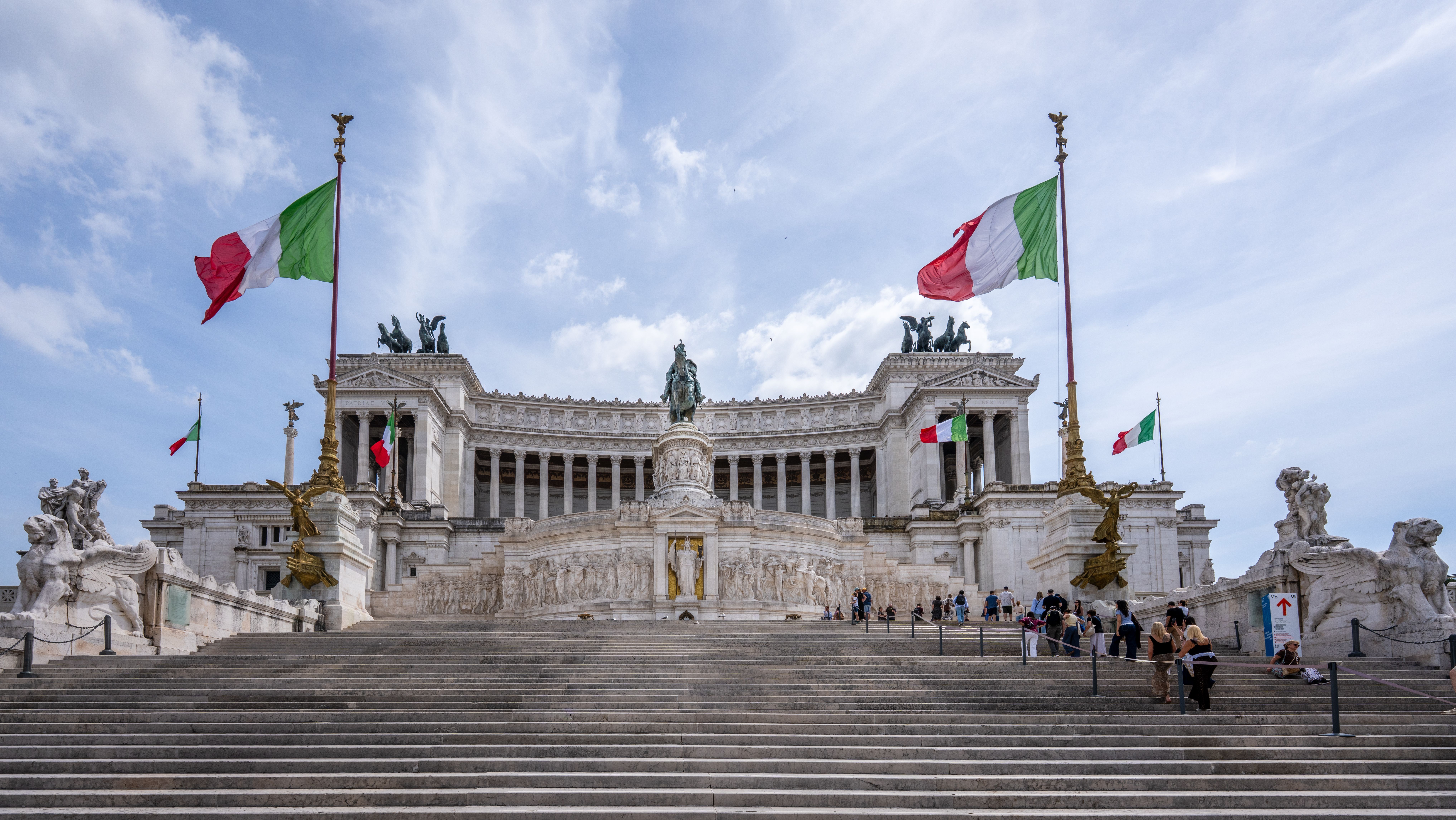 Stunning view of the Victor Emmanuel II Monument in Rome with Italian flags.