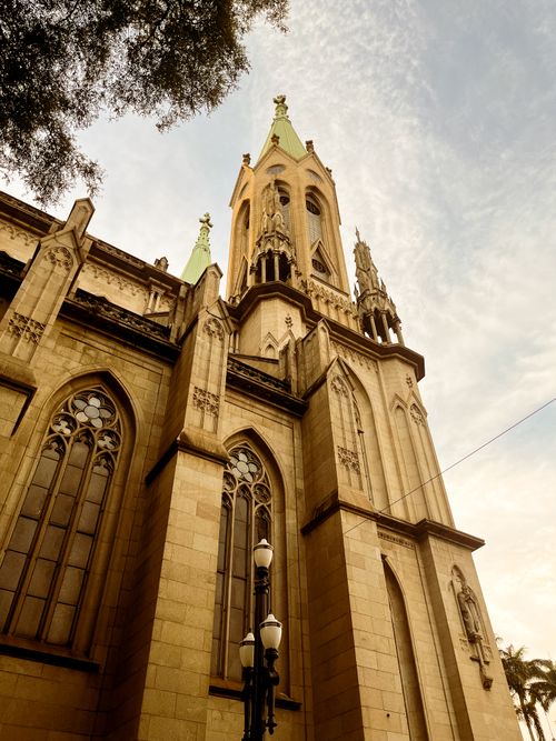 Free Soaring cathedral tower with gothic architecture under a clear sky. Stock Photo