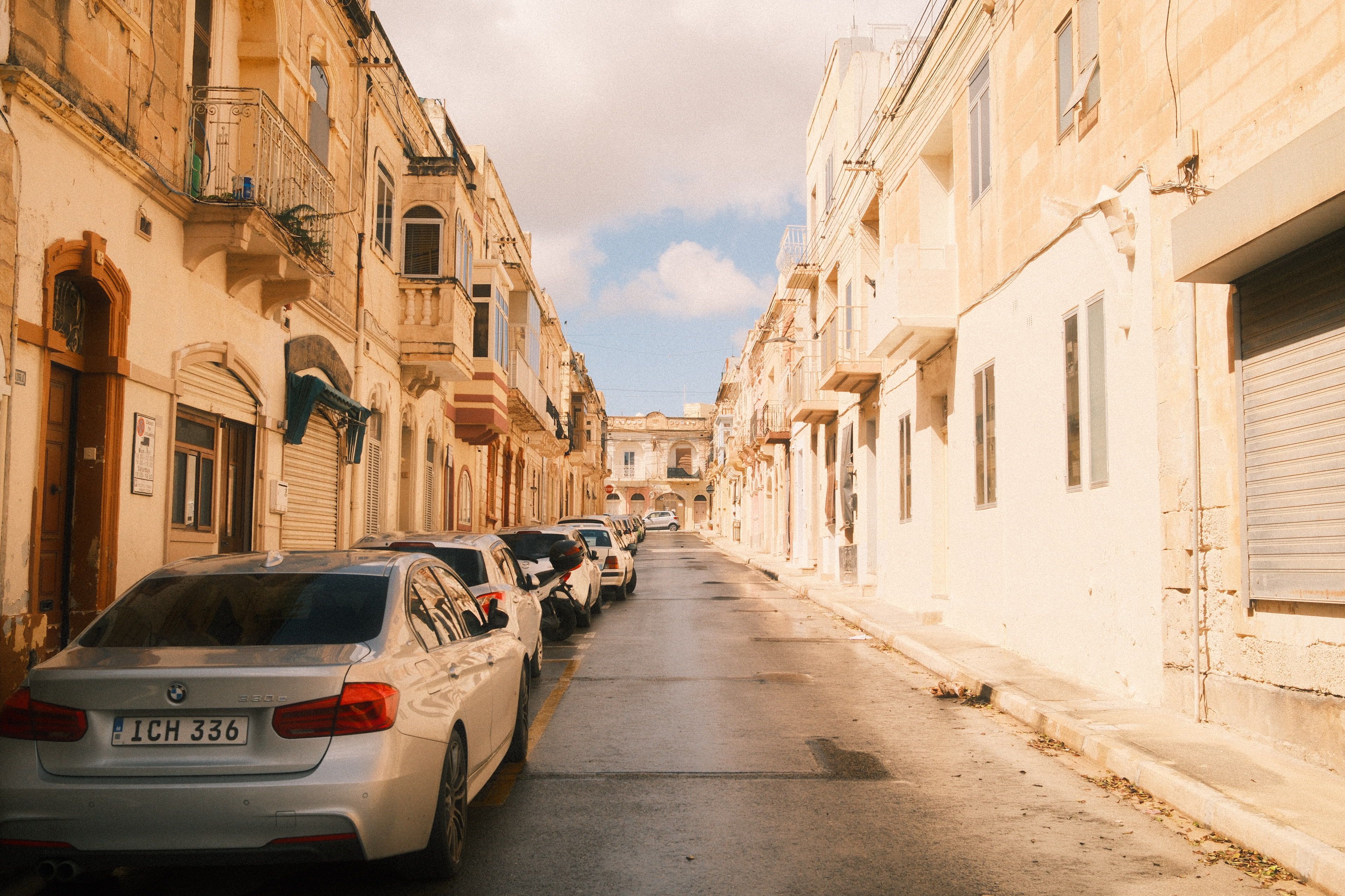 A car navigating a narrow, winding road in rural Malta