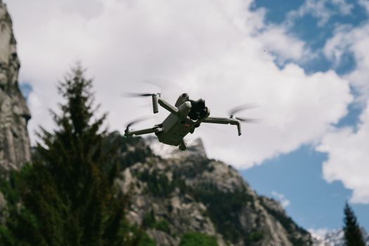 A drone soaring above the majestic peaks of the Italian Alps, captured on a clear day.