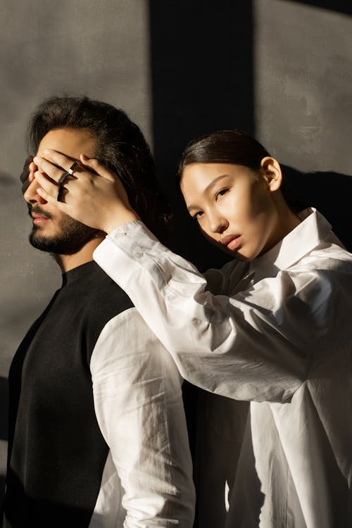 Free Woman Covering Man's Face Stock Photo