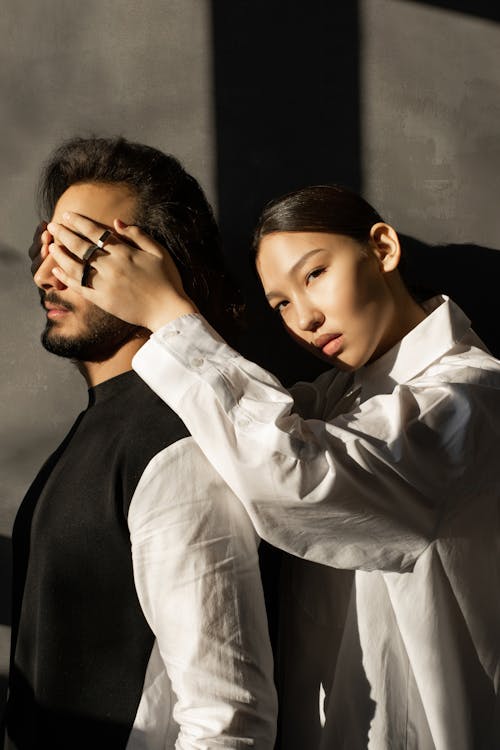 Free Woman Covering Man's Face Stock Photo